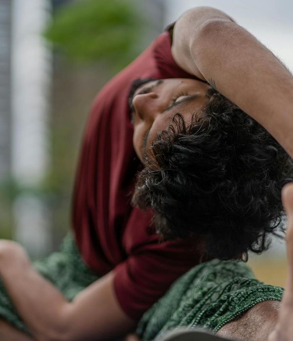 Man doing a deep stretching yoga pose, showing enhanced flexibility.